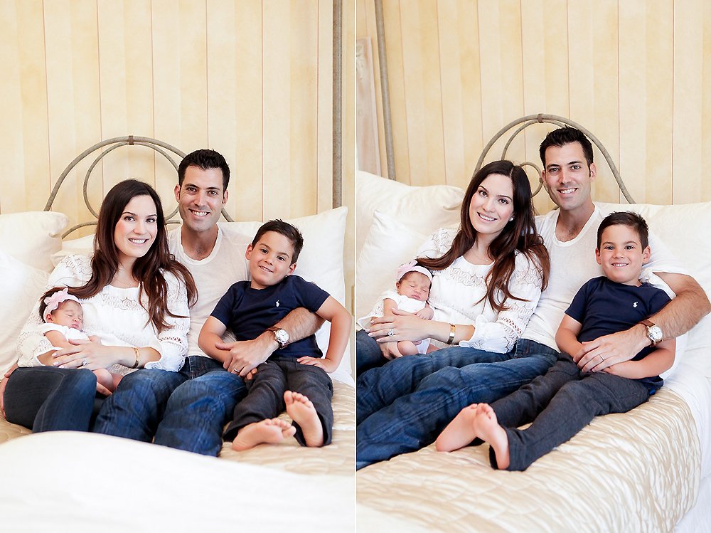 Mother and Father laying in bed holding toddler son and newborn baby girl during their Calabasas Newborn Photoshoot