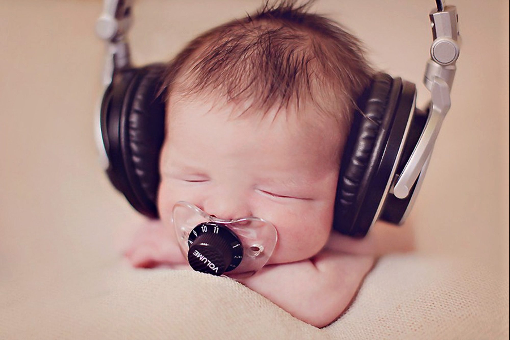 Baby wearing large headphones, relaxing.
