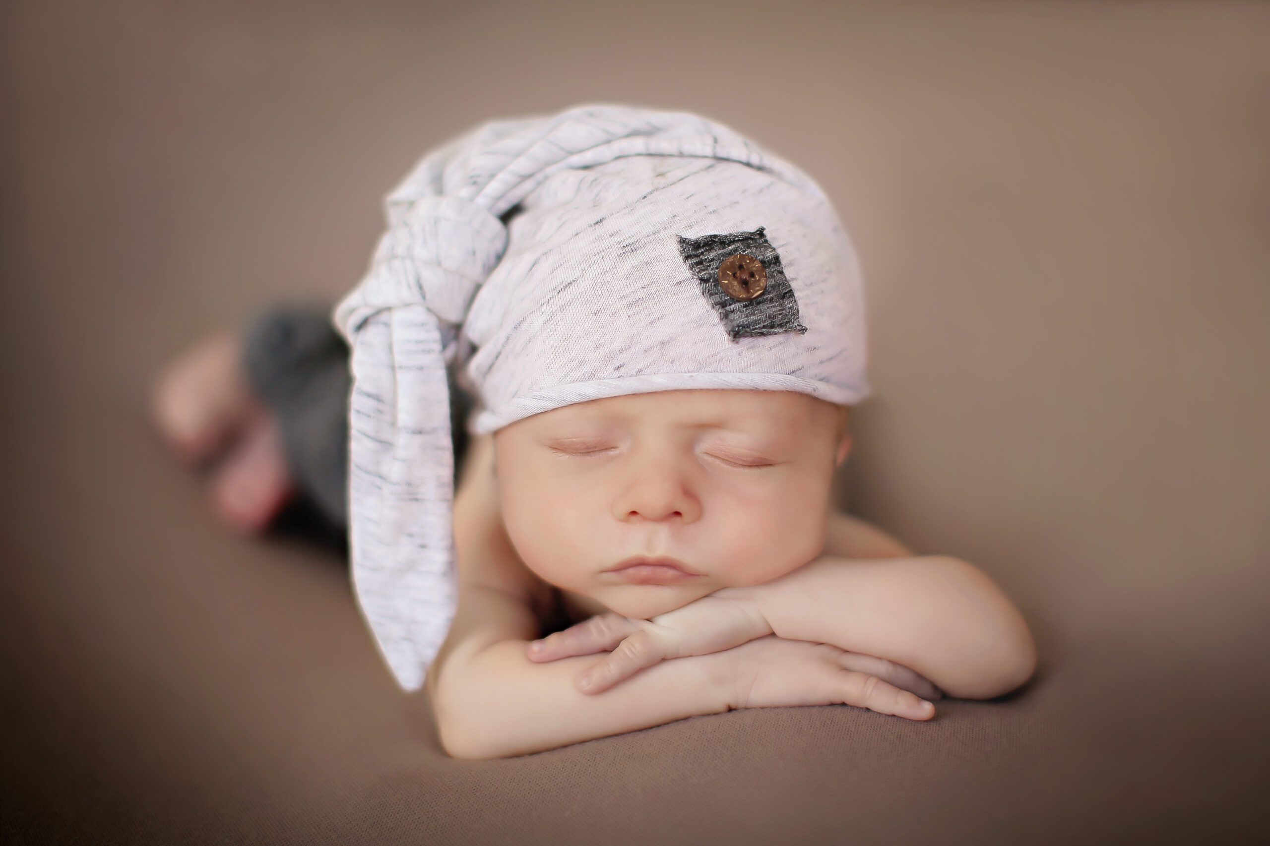 Newborn baby lying on soft surface.