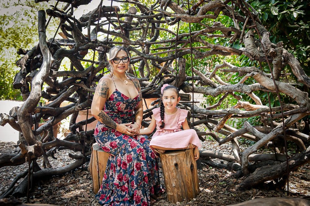 Mother and daughter in nature setting.