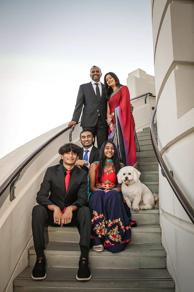 Holiday-Family-Portrait Session-Griffith Observatory-006 Family dressed elegantly on staircase at Griffith Park Observatory.