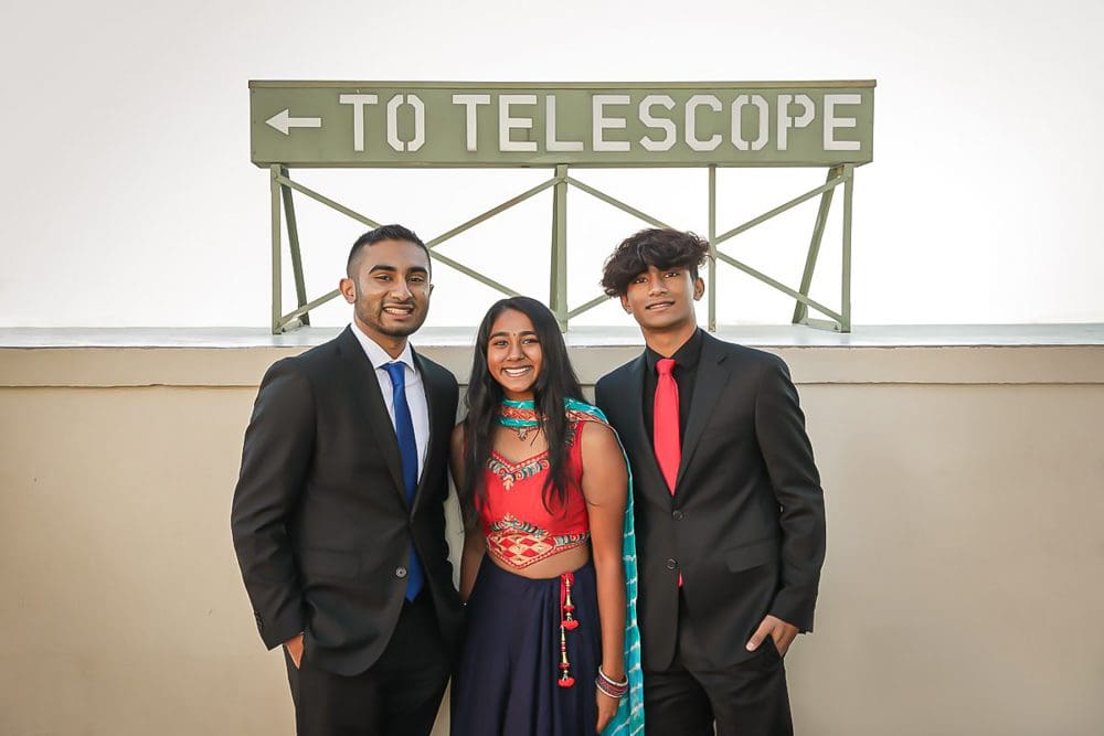 Three siblings in traditional Indian attire at Griffith Park Observatory