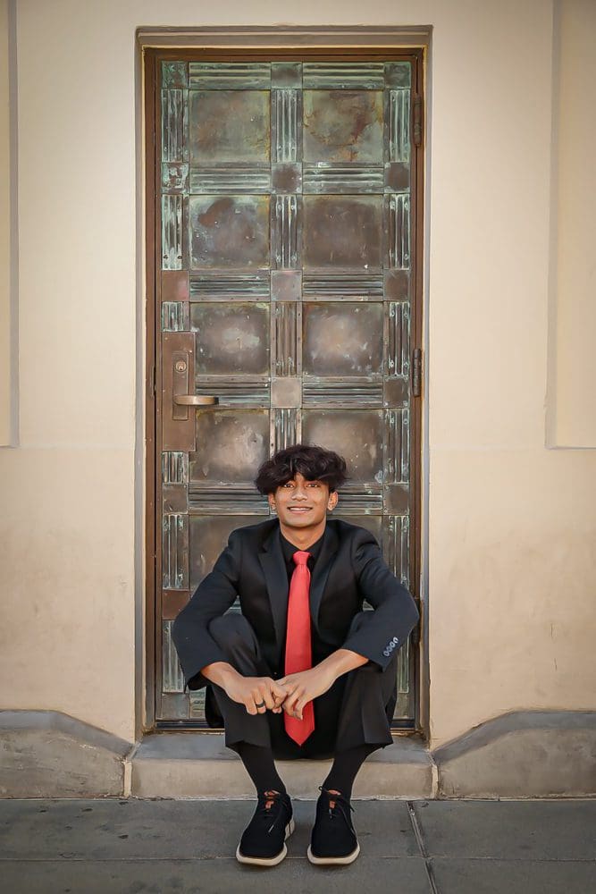 Holiday-Family-Portrait Session-Griffith Observatory-008 Child in suit sitting by door.