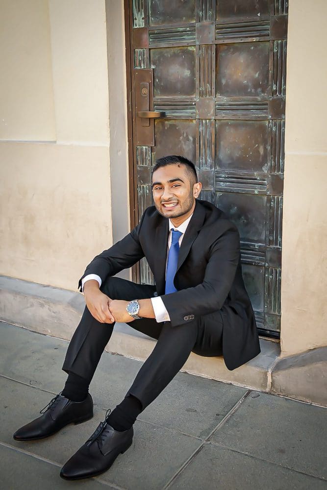 Holiday-Family-Portrait Session-Griffith Observatory-010 Man in suit sitting by door.