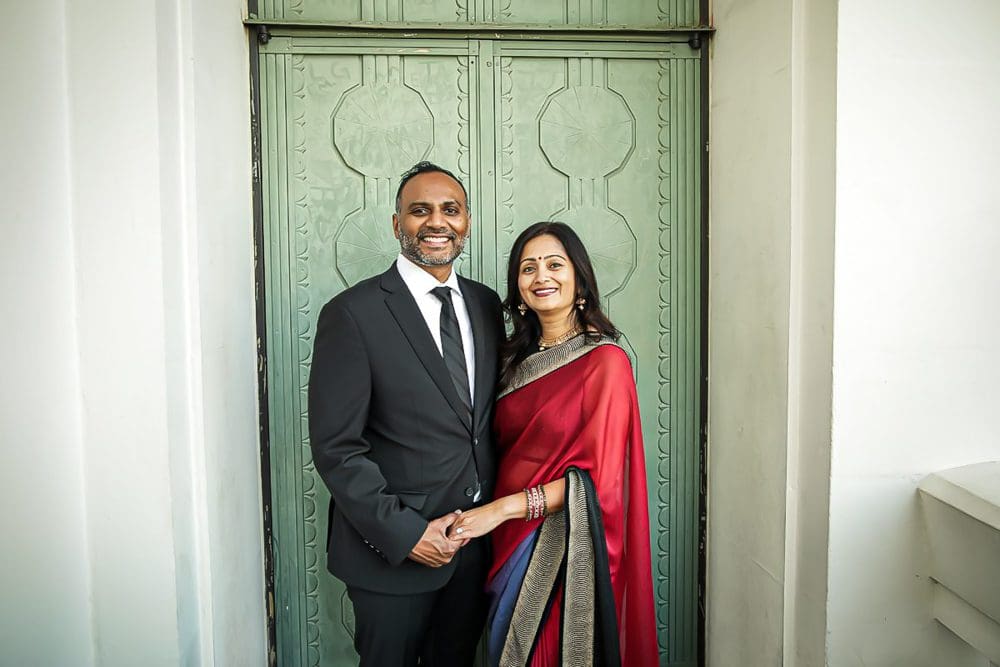 Holiday-Family-Portrait Session-Griffith Observatory-018 Couple in formal attire at doorway.