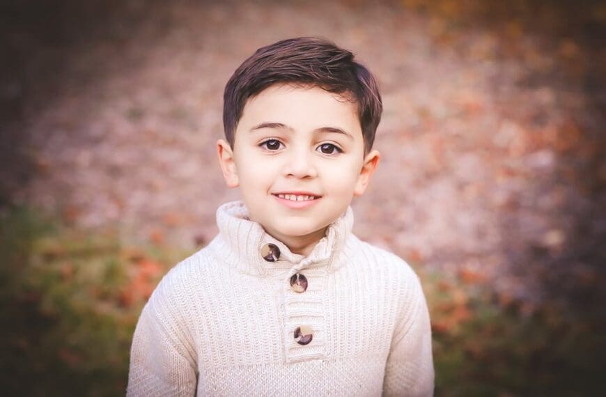 Child in cozy sweater outdoors.